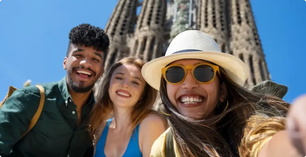 People doing a selfie in from of Sagrada Familia