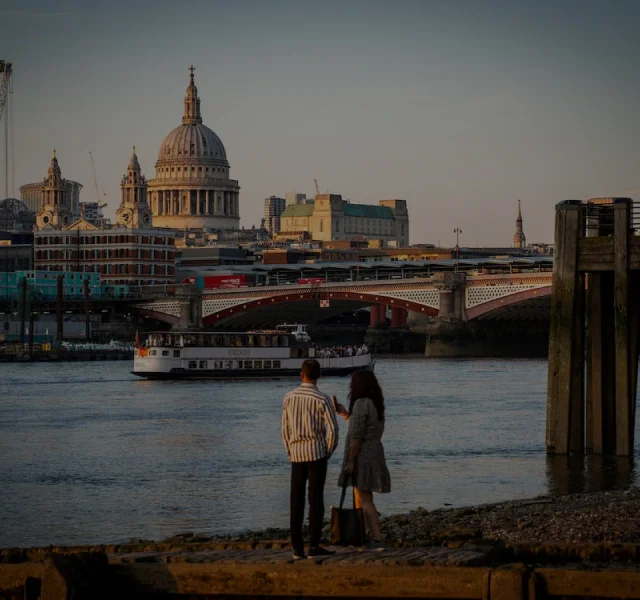 Couple taking photographs by the London river